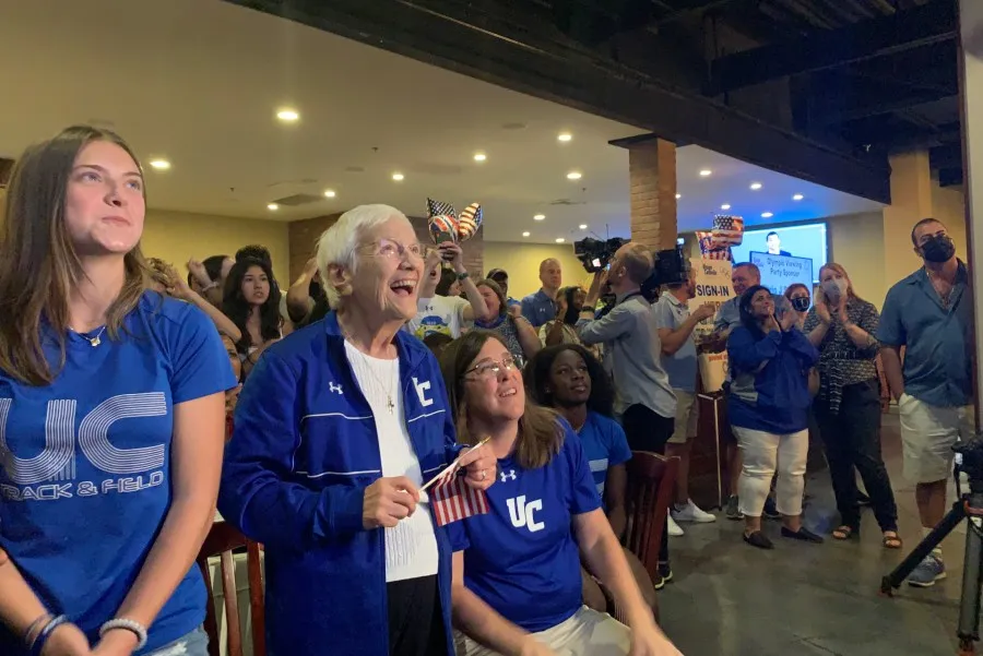 Sister Percylee Hart RSM, principal of Union Catholic Regional High School in New Jersey, sits in front a crowd of students, staff, and alumni as the crowd cheers on Sydney McLaughlin in her Gold medal race at the Tokyo Olympics.?w=200&h=150